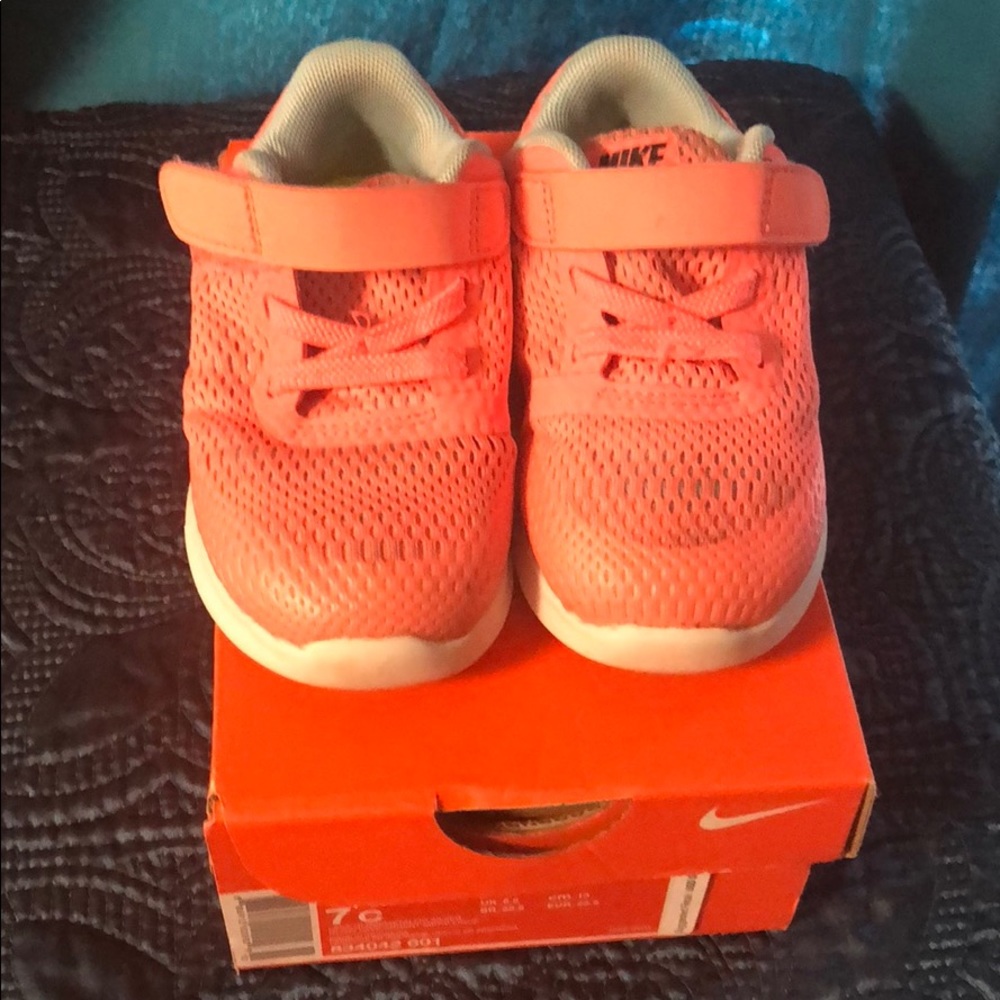 Used Nike Free RN lava flow and grey for size 7C.